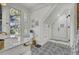 Elegant bathroom features a glass walk-in shower with white tiling, black accents, and a window view at 208 Sumter Ave, Summerville, SC 29483
