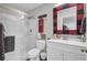 Modern bathroom with a glass-enclosed shower, white vanity, and red and black accents at 208 Sumter Ave, Summerville, SC 29483