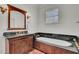 Classic bathroom features marble countertop vanity and jacuzzi tub encased in wood paneling at 208 Sumter Ave, Summerville, SC 29483