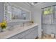 Bright bathroom vanity featuring marble countertops, decorative mirror, and modern fixtures at 208 Sumter Ave, Summerville, SC 29483