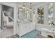 Bright bathroom features double sink vanity, black and white patterned flooring, and a large window at 208 Sumter Ave, Summerville, SC 29483