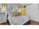 Bright bedroom featuring a comfortable bed, yellow wardrobe, and sunny window at 208 Sumter Ave, Summerville, SC 29483