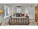 Bright bedroom featuring a cozy bed with decorative pillows, two windows and side tables with lamps at 208 Sumter Ave, Summerville, SC 29483