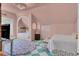 Serene pink bedroom features a built-in bed alcove, unique ceiling fixture, and green and white checkered floors at 208 Sumter Ave, Summerville, SC 29483