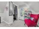 Stylish bedroom features a cozy red chair, closet, and a bright window at 208 Sumter Ave, Summerville, SC 29483