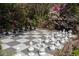 Outdoor chess board with black and white pieces surrounded by blooming azaleas at 208 Sumter Ave, Summerville, SC 29483