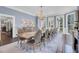 Elegant dining room featuring a grand chandelier and large windows that fill the space with natural light at 208 Sumter Ave, Summerville, SC 29483
