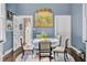 Cozy dining room with blue walls, a round table with seating for four, and a statement chandelier at 208 Sumter Ave, Summerville, SC 29483