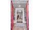View of the bright entryway featuring red double doors, floral wallpaper, a chandelier, and a staircase at 208 Sumter Ave, Summerville, SC 29483