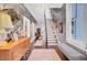 Spacious entryway boasts floral wallpaper, a crystal chandelier, a wooden dresser, and a staircase at 208 Sumter Ave, Summerville, SC 29483