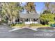 Charming coastal cottage with a front porch and lush landscaping at 208 Sumter Ave, Summerville, SC 29483