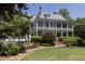Stately home with a manicured lawn, brick pathway, and a decorative water fountain at 208 Sumter Ave, Summerville, SC 29483