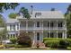 Beautiful home with a large front yard, mature trees, and a charming water fountain creates a welcoming ambiance at 208 Sumter Ave, Summerville, SC 29483
