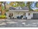 Charming cottage-style home with covered porch and seating area, perfect for relaxing outdoors at 208 Sumter Ave, Summerville, SC 29483