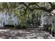 Lush landscaping surrounds a house with arched windows and multiple entertainment spaces at 208 Sumter Ave, Summerville, SC 29483