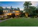 Elegant exterior of a grand home at dusk, featuring manicured grounds and inviting lighting at 208 Sumter Ave, Summerville, SC 29483