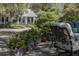 Picturesque cottage nestled amidst trees and plants, featuring a welcoming porch at 208 Sumter Ave, Summerville, SC 29483