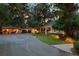 Elegant exterior showcasing a well-manicured lawn, spacious driveway, and charming curb appeal at 208 Sumter Ave, Summerville, SC 29483