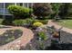 Charming front yard featuring brick pathways, decorative garden beds, and a lovely water fountain at 208 Sumter Ave, Summerville, SC 29483