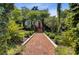Beautifully landscaped yard with a brick path leading to a house with a red door, framed by lush greenery at 208 Sumter Ave, Summerville, SC 29483