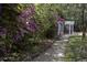 Scenic garden path with blooming azaleas leading to a charming white pergola with seating at 208 Sumter Ave, Summerville, SC 29483