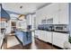 Spacious kitchen featuring a large blue island, white cabinetry, granite countertops, and stainless steel appliances at 208 Sumter Ave, Summerville, SC 29483