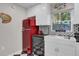 Bright kitchen with white cabinets, a vintage-style red refrigerator, and black and white backsplash at 208 Sumter Ave, Summerville, SC 29483