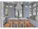 Bright kitchen features a large marble island with seating, stainless steel appliances, and unique light fixture at 208 Sumter Ave, Summerville, SC 29483