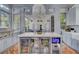 This well appointed kitchen includes a large marble island and built-in drink refrigerators at 208 Sumter Ave, Summerville, SC 29483