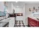 Charming kitchen features checkerboard floors, modern appliances, and a retro diner booth at 208 Sumter Ave, Summerville, SC 29483