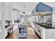 Bright kitchen features white cabinets, stainless steel appliances, granite countertops, and a large island with breakfast bar at 208 Sumter Ave, Summerville, SC 29483