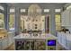 Modern kitchen featuring a marble island with beverage refrigerators, flowing into the outdoor patio at 208 Sumter Ave, Summerville, SC 29483