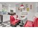 Retro-style kitchen nook with booth seating, a black and white tile floor, and diner-themed decor at 208 Sumter Ave, Summerville, SC 29483
