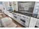 Close-up view of a stainless steel, professional-grade gas range with double ovens and dark granite countertop at 208 Sumter Ave, Summerville, SC 29483