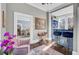 Stylish living room with wet bar, painting and cozy pink armchairs at 208 Sumter Ave, Summerville, SC 29483