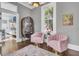 Inviting seating area with view of the wet bar and kitchen with pink chairs at 208 Sumter Ave, Summerville, SC 29483