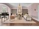 Elegant living room featuring a grand piano, fireplace, chandelier, and stylish seating at 208 Sumter Ave, Summerville, SC 29483