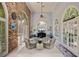 Cozy living room featuring a brick accent wall, arched windows, and comfortable seating at 208 Sumter Ave, Summerville, SC 29483
