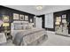 Modern main bedroom with black walls, silver bedding, large windows, and mirrored nightstand at 208 Sumter Ave, Summerville, SC 29483