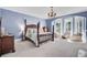 Spacious bedroom features four-poster bed, chandelier, and bay window seating area with great lighting at 208 Sumter Ave, Summerville, SC 29483