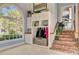 Charming mudroom featuring storage cabinets, a sink, a large window, and staircase with brick risers at 208 Sumter Ave, Summerville, SC 29483