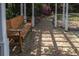Cozy outdoor seating area with a wooden bench overlooking a brick path and lush greenery at 208 Sumter Ave, Summerville, SC 29483