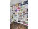 Walk-in pantry with custom shelving filled with food items, cleaning supplies, and other household goods at 208 Sumter Ave, Summerville, SC 29483
