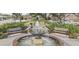 Beautiful park with a water fountain surrounded by benches and lush greenery at 208 Sumter Ave, Summerville, SC 29483