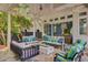 Relaxing covered patio with plush seating, hanging swing, and an outdoor dining area at 208 Sumter Ave, Summerville, SC 29483