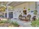 Inviting porch with wicker chairs, a small table, and colorful decorative elements on the exterior wall at 208 Sumter Ave, Summerville, SC 29483