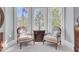 Relaxing sitting area bathed in natural light, featuring comfortable chairs and a decorative table at 208 Sumter Ave, Summerville, SC 29483