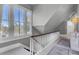 Well-lit staircase with white railings, natural light, and landing with wood accents at 208 Sumter Ave, Summerville, SC 29483