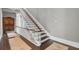 Traditional staircase with wood accents, white railings, and a cozy runner at 208 Sumter Ave, Summerville, SC 29483