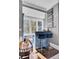 The wet bar has shelves of glasses, a painting and barstool seating at 208 Sumter Ave, Summerville, SC 29483